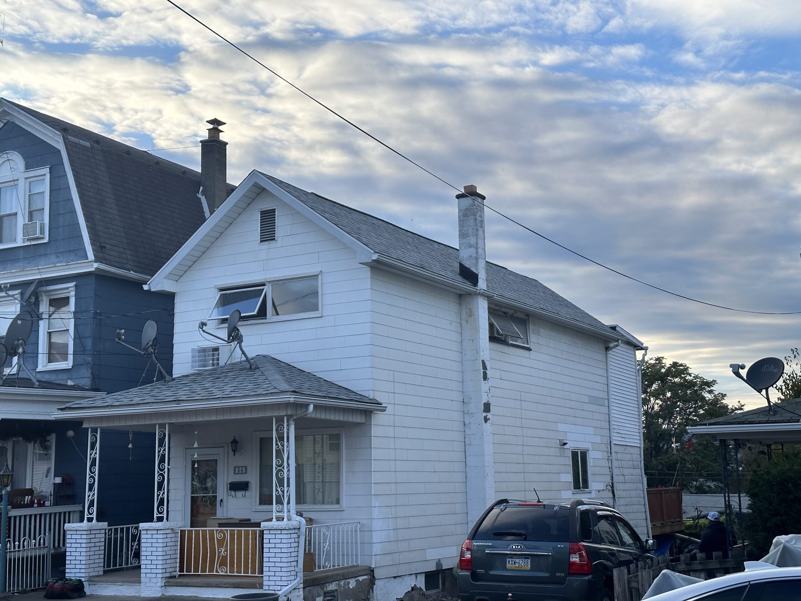 Professional Roof Repair in Dallas, PA repairing damaged shingles on residential roof